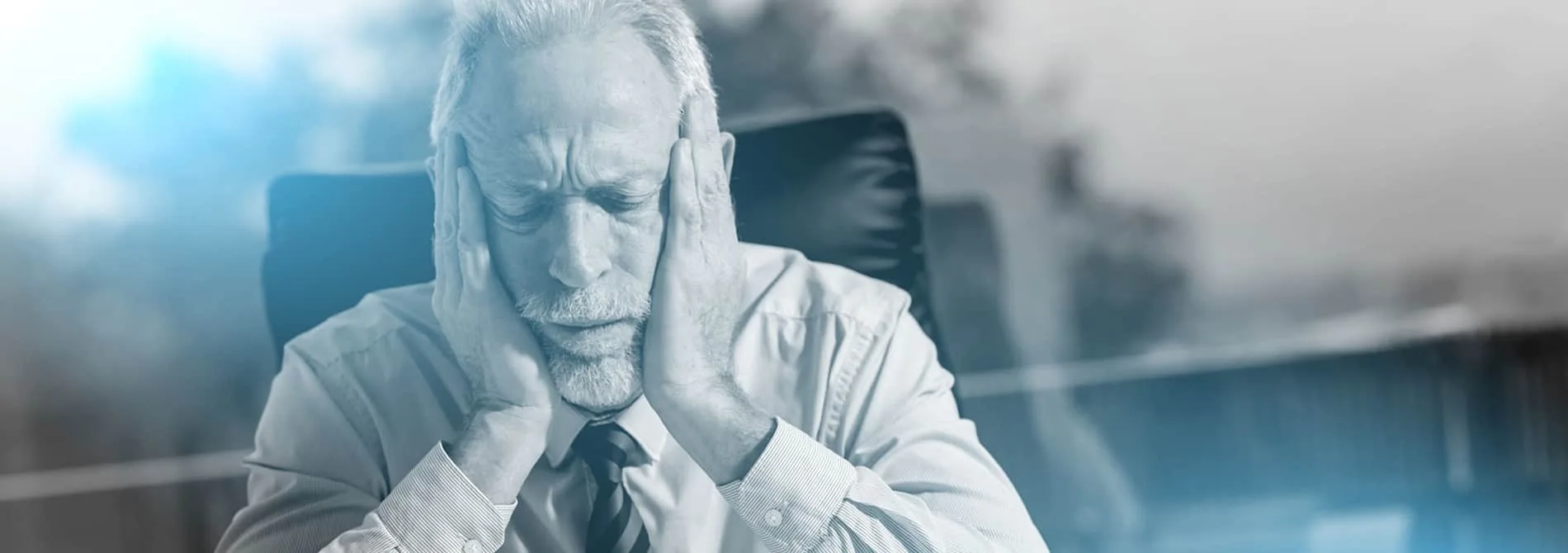 Tired businessman sitting in office