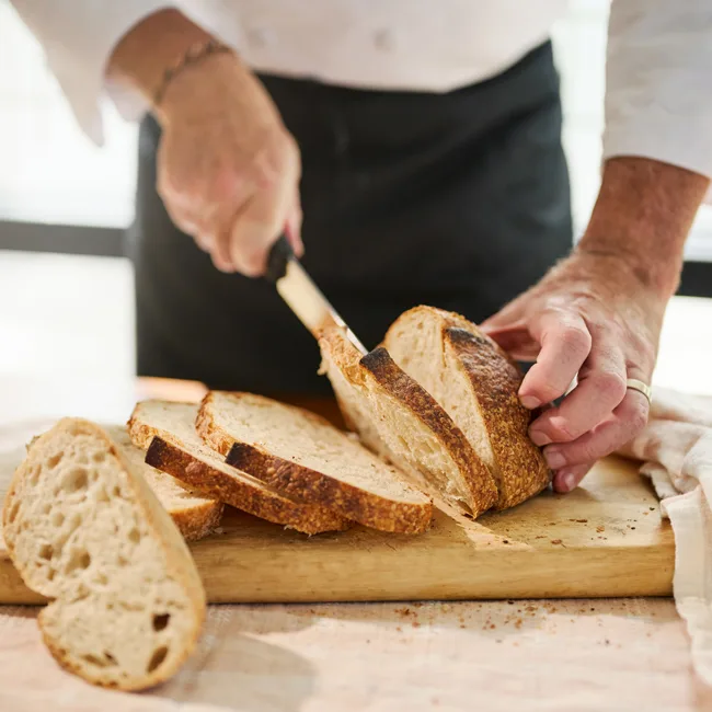 Chef cutting bread