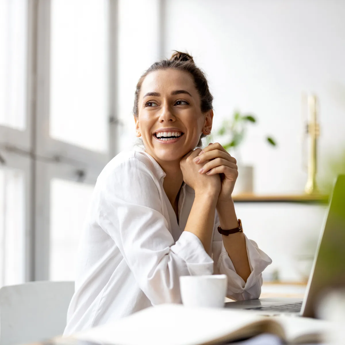 Woman smiling working on laptop