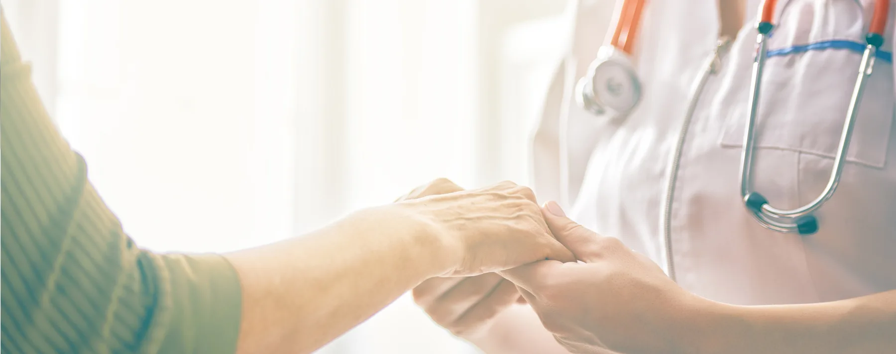 Nurse holding a patient's hand