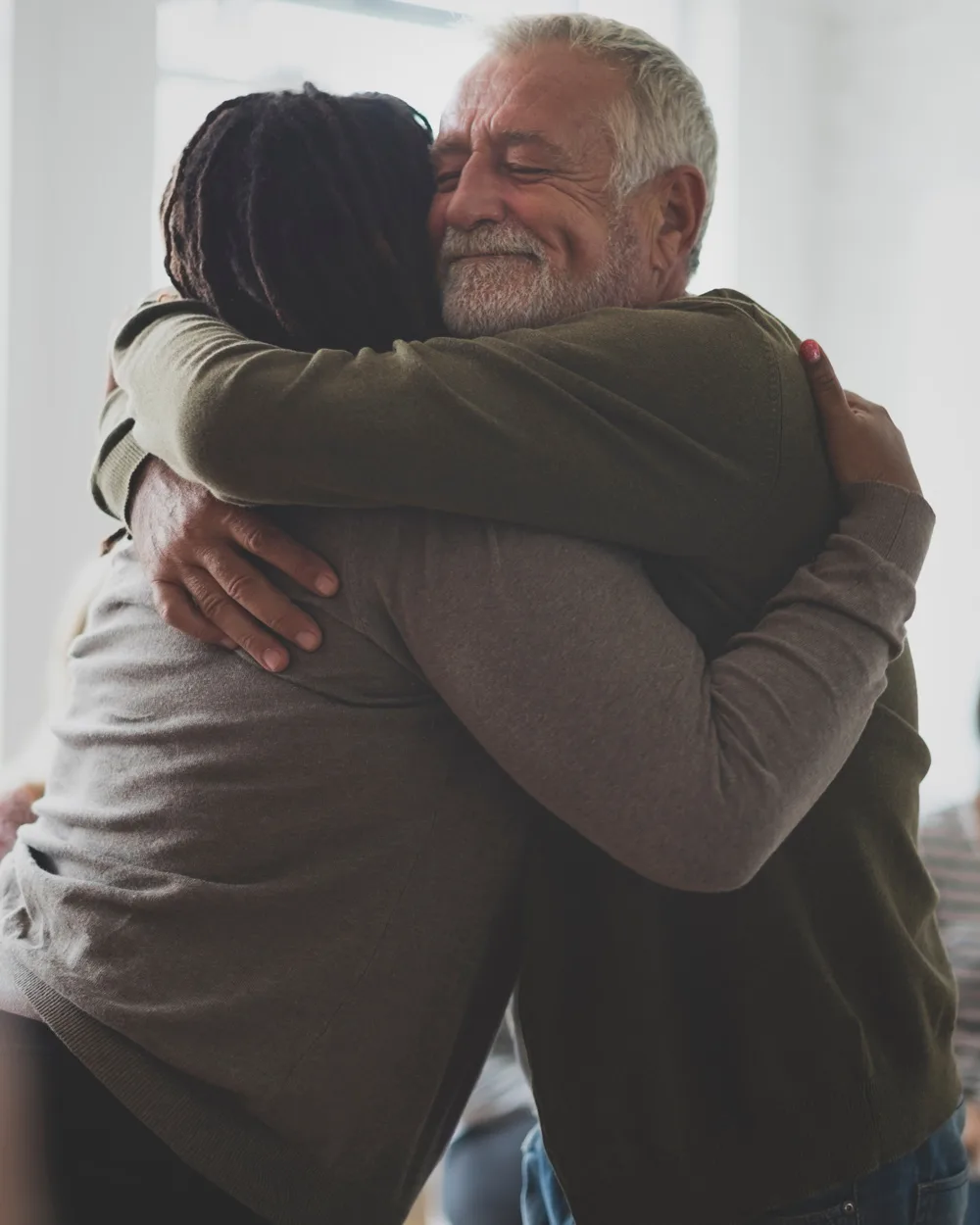 Man and woman hugging during group