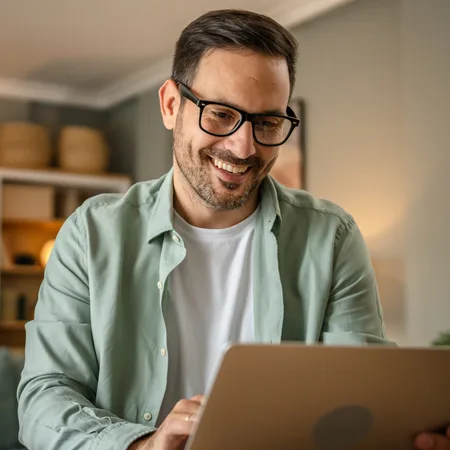 Man smiling at laptop