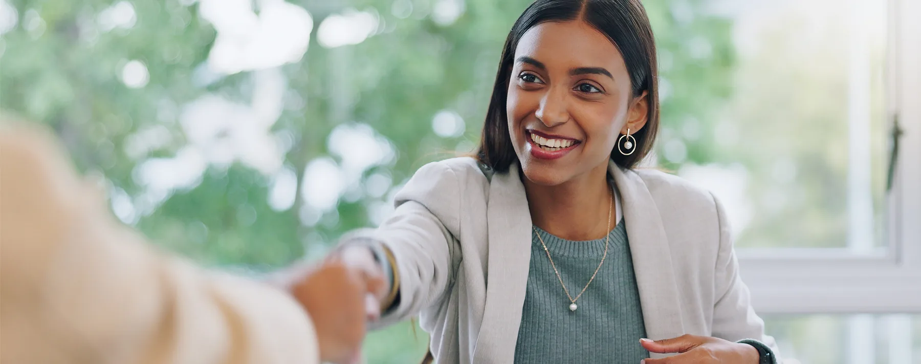 woman shaking someone's hand